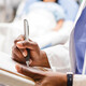 doctor uses paper charting in front of patient