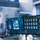 healthcare researcher looks at images and data on monitors