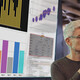 man gives presentation in front of screen with charts