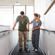 nurse helps veteran walk for rehab