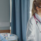 doctor looks at data on computer at the bedside