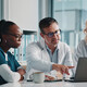 clinicians look at data on laptop