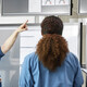 Medical professionals discussing over screens 