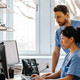 clinicians looking at computer monitor in office