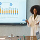 doctor gives presentation in front of chart