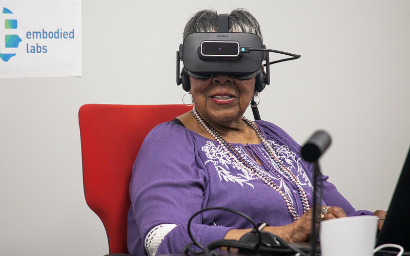 Older adult woman wears VR headset