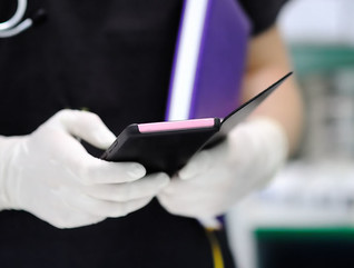 Nurse holding purple smartphone
