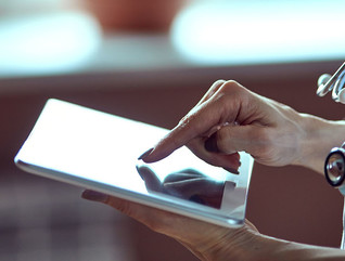 Woman doctor using tablet computer in hospital