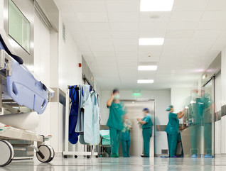 Blurred figures of people with medical uniforms in hospital corridor