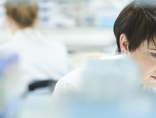 scientist in a busy research lab