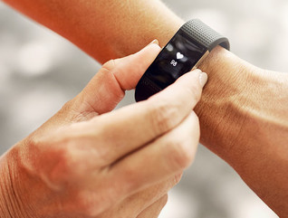 Shot of an unrecognizable woman checking her fitness tracker after a run