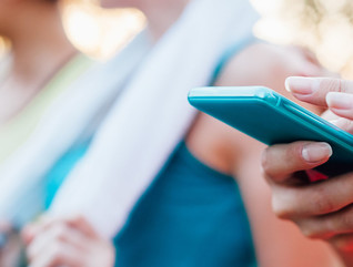 Sports woman checking fitness result on mobile phone