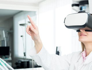 Horizontal color image of female dentist using virtual reality simulator at modern clinic.