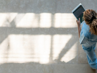 Nurse walking with tablet