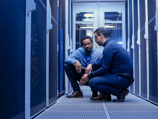 Two engineers in server room