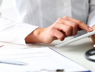 Doctor reads patient data on tablet