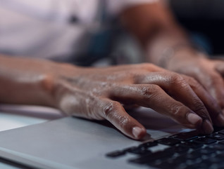 Doctor types on computer