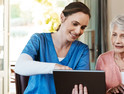 nurse and older adult with tablet