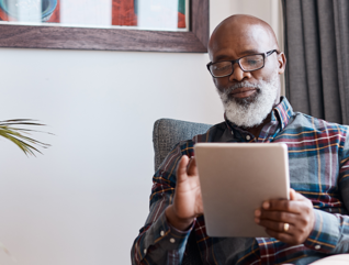 Senior in home with tablet