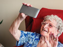 Elderly woman using a mobile telephone.