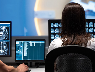 male and female clinicians review medical images