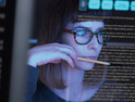 woman analyzes data on computer screen