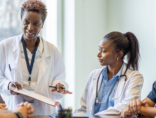 doctor meets with nurses