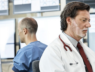 Doctors using computers in control room