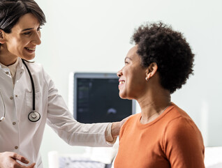 Doctor speaking to middle age woman