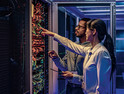 two IT experts assess a data center