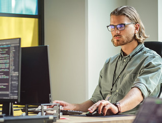 IT person looks at computer screen filled with code