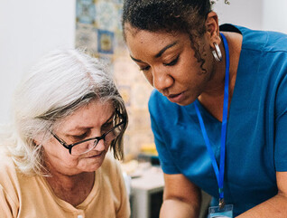 Nurse assisting senior patient