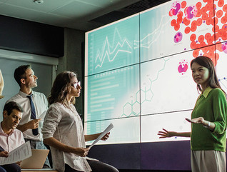 group of scientists look at medical information on a large screen