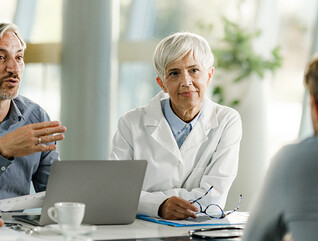 Team of doctors and businessmen having a meeting