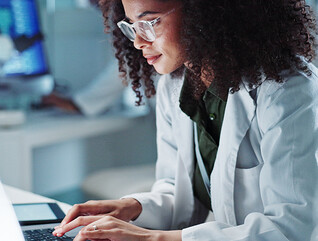 Doctor on laptop in state-of-the-art lab