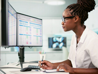 Women at desk working on computer