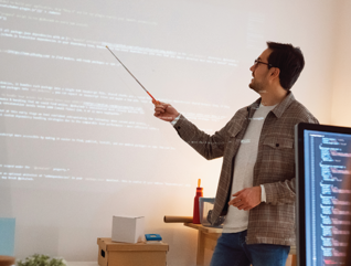 man teaches coding class using projector