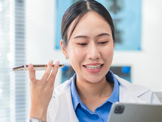 Doctor using phone to dictate to tablet