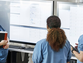 Doctors reviewing information boards