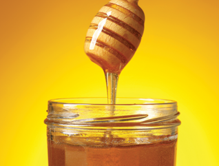 jar of honey with a honey dipper