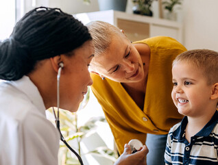 Pediatrician working with patient