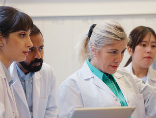 doctors gathered around computer
