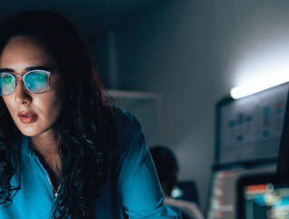 cybersecurity expert surrounded by code