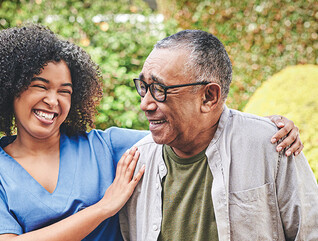 nurse and senior laughing