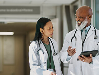 two doctors smile as they walk