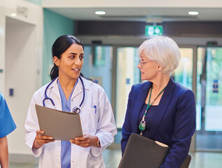 Hospital workers walking down a hallway