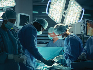 medical team performs surgery in dark room