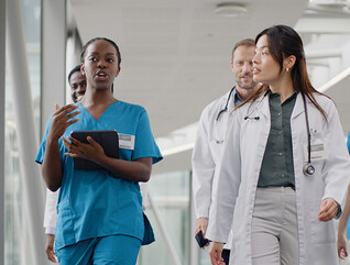 clinicians walking in hospital hallway