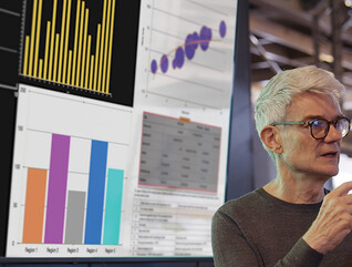 man gives presentation in front of screen with charts