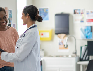 doctor and patient smiling at appointment